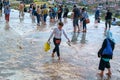 Pamukkale, Turkey - April 26, 2015: Tourists walk on the water flowing from the travertine terraces.