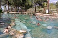 Pamukkale, Turkey - April 26, 2015: Unidentified tourists swim in the Antique pool - Cleopatra's Bath.