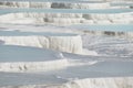 Pamukkale in Turkey is known for its mineral-rich thermal waters flowing down white travertine terraces.