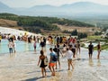 Tourists visiting Pamukkale tranvertines or Cotton Castle, Turkey