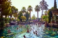 PAMUKKALE, TURKEY - September 17, 2017: Unidentified tourists swim in the Antique pool Cleopatra`s Bath in Pamukkale. It`s a