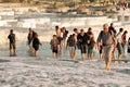 Landmark attraction. Landscape. Ruins of Hierapolis city and tourists on famous terraces of Pamukkale, Turkey, at sunset Royalty Free Stock Photo