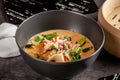 Pan-Asian cuisine concept. Japanese miso soup Tom Yam Kung with seafood, shrimps, mussels, calamari. Serving dishes Royalty Free Stock Photo