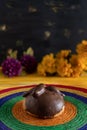 Pan de Muerto, Bread of Dead Mexican Sugar Scone and Chocolate on Woven Tablecloth.