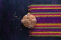 Pan de Muerto, Bread of Dead Mexican Sugar Scone on Woven Tablecloth. Royalty Free Stock Photo