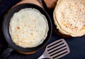 Pan with delicious thin Crepes on wooden board. Homemade thin pancakes