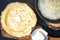 Pan with delicious thin Crepes on wooden board. Homemade thin pancakes