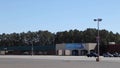 Pan of a empty Covid-19 vaccine clinic building set up with orange cones and parking lot