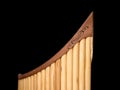 Pan flute in front of black background Royalty Free Stock Photo