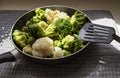 The pan with fresh defrosted vegetables and kitchen spatula Royalty Free Stock Photo