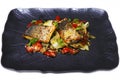 Pan fried Atlantic sea bass fillet with Mediterranean style sauteed fennel, chicory and cherry tomato with lemon sauce Royalty Free Stock Photo