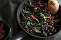 Pan - fried black cabbage, red beans, chili and bread. Royalty Free Stock Photo