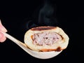 Pan-fried bun in a spoon isolated Royalty Free Stock Photo