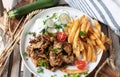 Fried pork fillet with homemade french fries and zucchini salad on a plate Royalty Free Stock Photo