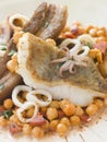 Pan Fried Cod Fillet and Baby Squid with Beans Royalty Free Stock Photo