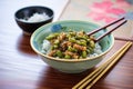 pan-fried edamame with sesame seeds, chopsticks aside Royalty Free Stock Photo