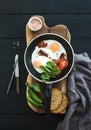 Pan of fried eggs, bacon, tomatoes with bread Royalty Free Stock Photo