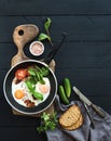 Pan of fried eggs, bacon, tomatoes with bread Royalty Free Stock Photo