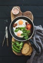 Pan of fried eggs, bacon, tomatoes with bread Royalty Free Stock Photo