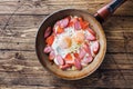 Pan with fried eggs sausages and tomatoes on the table. Rich homemade Breakfast Royalty Free Stock Photo