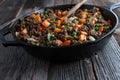 Pan fried ground beef with peas and carrots in a cast iron pan Royalty Free Stock Photo