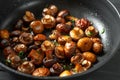Pan of fried mushrooms champignons on a dark wooden background. Top view. Place for text and copy space. Mushrooms are