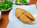 The pan-fried native fish and stir-fried vegetables on the table.