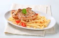 Pan fried pork chops with fries Royalty Free Stock Photo
