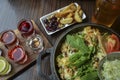 Pan with fried potatoes with meat and cheese, supplemented with greens, salad and tomato and snacks Royalty Free Stock Photo