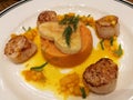 Pan fried seared Hokkaido scallop served with creamy mashed sweet potato and orange sauce top with heart pie. Special dish for cel