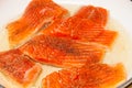 Pan frying red trout fillets, also known as arctic char Royalty Free Stock Photo