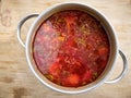 Pan full of Ukrainian borshch standing on a wooden surface Royalty Free Stock Photo