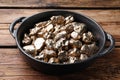 Pan of gold nuggets on wooden table, closeup Royalty Free Stock Photo