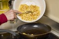 a pan with ingredients for preparing scrambled eggs, cheese, fried potatoes Royalty Free Stock Photo