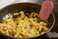 a pan with ingredients for preparing scrambled eggs, cheese, fried potatoes Royalty Free Stock Photo