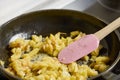 a pan with ingredients for preparing scrambled eggs, cheese, fried potatoes Royalty Free Stock Photo