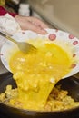 a pan with ingredients for preparing scrambled eggs, cheese, fried potatoes Royalty Free Stock Photo