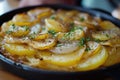 A pan of Lyonnaise potatoes with herbs and spices. Royalty Free Stock Photo