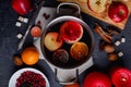 A pan with a mulled wine with orange, lemon, apples and cinnamon. View from above.