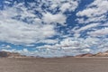 Pan of the Namibia desert with mountains and cloudy sky. Royalty Free Stock Photo