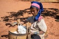 Pan Pet, Kayah State, Myanmar - February 2020: Portrait of an elderly Kayan longneck woman or Paduang spinning cotton