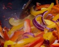 Pan frying red onion, yellow pepper and red pepper Royalty Free Stock Photo