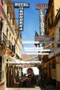 Tourists relaxing at a shaded pavement cafe, Ronda, Spain.