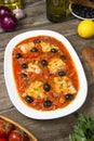 Pan seared fish with tomatoes and olives. Selected focus.