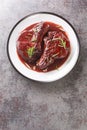 Pan Seared Pork Chops with red wine sauce and herbs closeup on the plate. Vertical top view Royalty Free Stock Photo