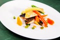 Pan seared sea bass served with vegetables