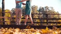 Legs of a couple dancing on the wooden bridge