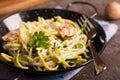 Pan of spaghetti prepared from zucchini and mushroom sauce on wooden table Royalty Free Stock Photo