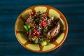 Pan of traditional Japanese yakitori dish - fried checken hearts served with sesame, teriyaki sauce and fresh vegetables at wooden Royalty Free Stock Photo