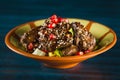 Pan of traditional Japanese yakitori dish - fried checken hearts served with sesame, teriyaki sauce and fresh vegetables at wooden Royalty Free Stock Photo